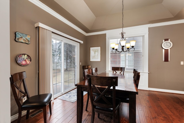 dining room with baseboards, a chandelier, a raised ceiling, and dark wood-style flooring