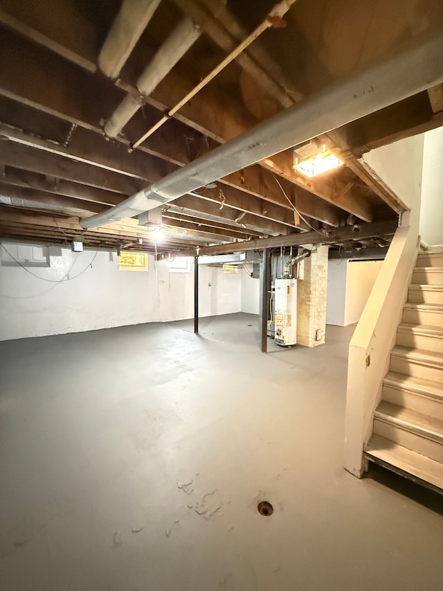 below grade area featuring gas water heater and stairway