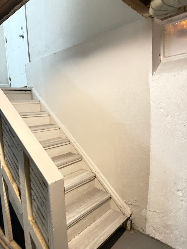 staircase with concrete floors