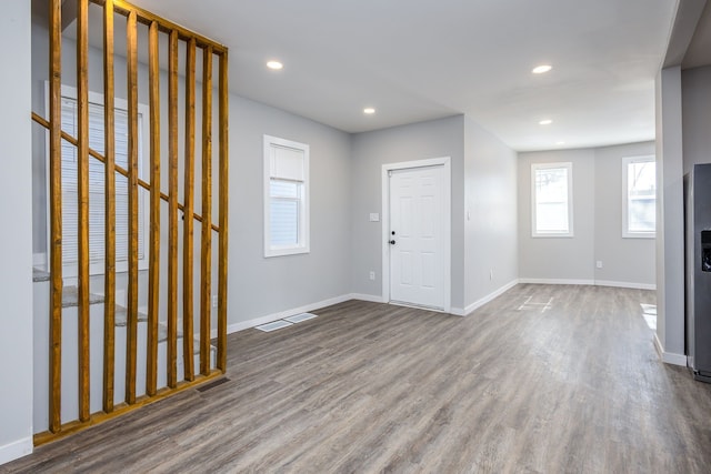 foyer entrance with recessed lighting, visible vents, baseboards, and wood finished floors