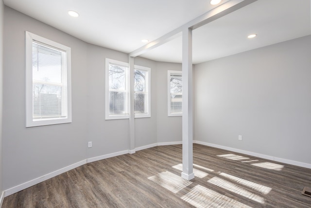 below grade area featuring recessed lighting, wood finished floors, and baseboards