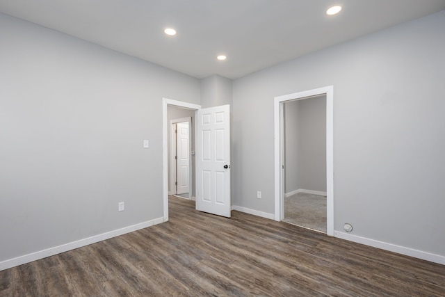 unfurnished bedroom featuring baseboards, dark wood-type flooring, and recessed lighting