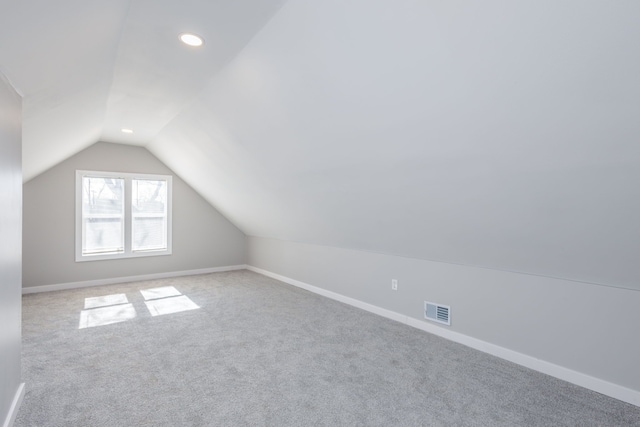 additional living space featuring carpet, lofted ceiling, recessed lighting, visible vents, and baseboards