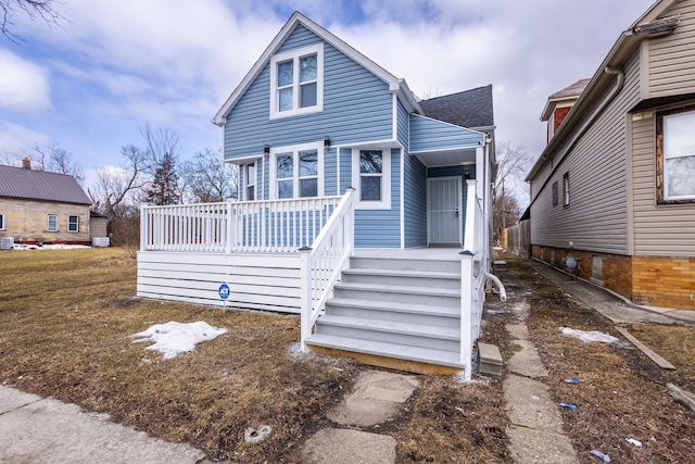 view of front of property featuring roof with shingles