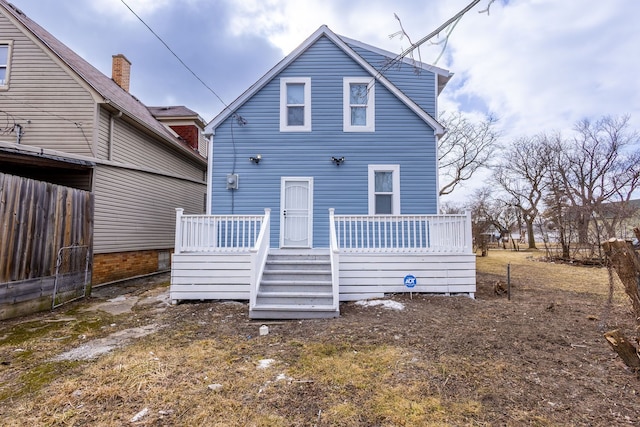 rear view of property with a wooden deck