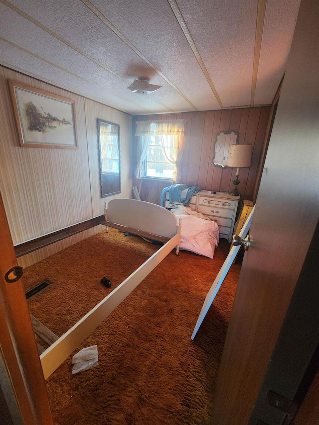 unfurnished bedroom with carpet flooring, visible vents, and a textured ceiling