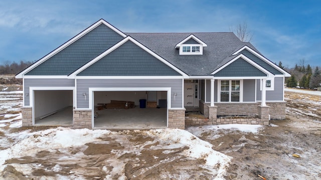 craftsman inspired home with stone siding, roof with shingles, and an attached garage