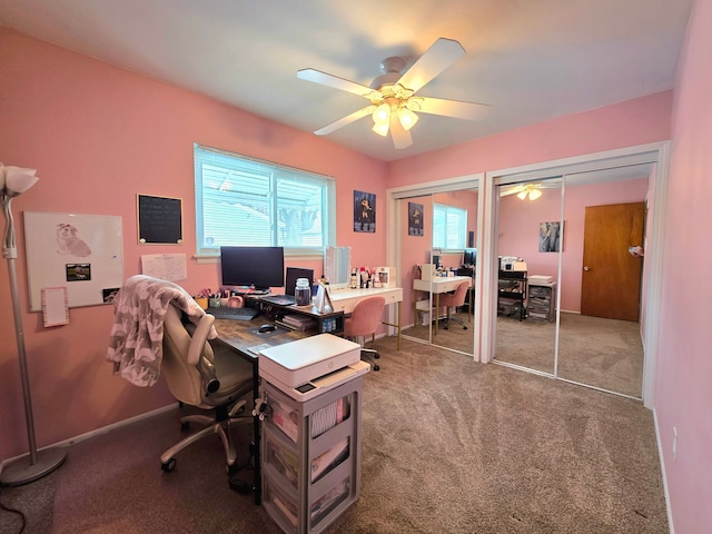 home office featuring carpet floors, ceiling fan, and baseboards