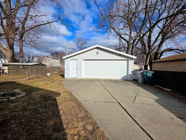 detached garage featuring fence