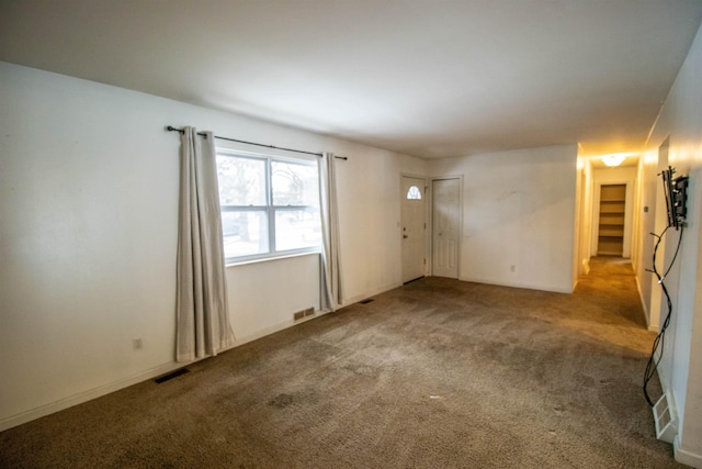 carpeted spare room with visible vents