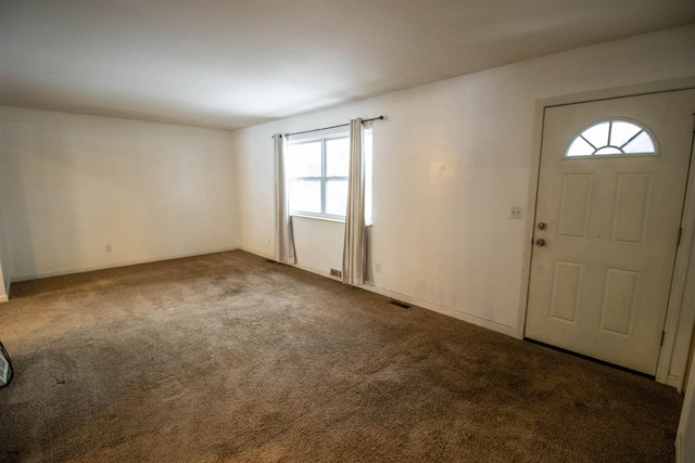 entrance foyer featuring carpet floors and visible vents