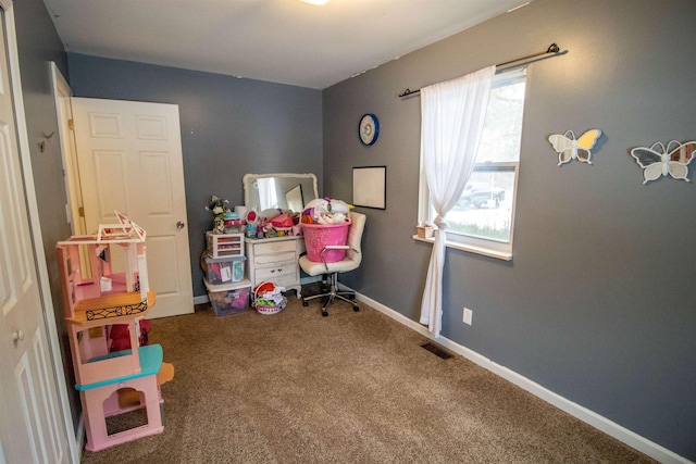 carpeted office with baseboards and visible vents