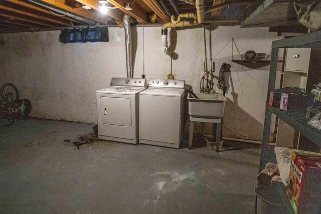 unfinished basement featuring a sink and washer and dryer