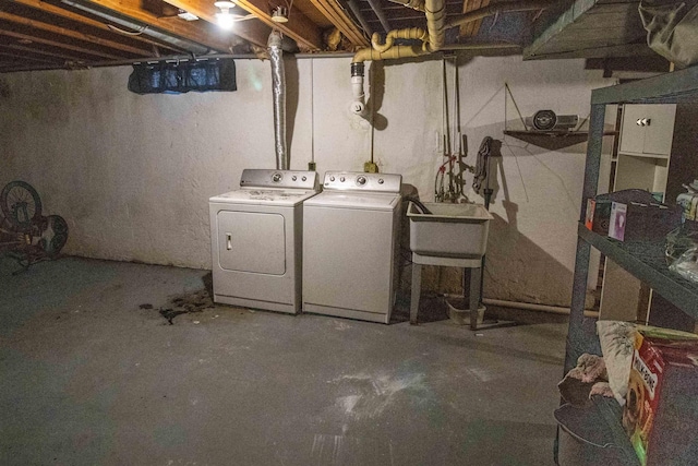 unfinished basement featuring washing machine and dryer and a sink