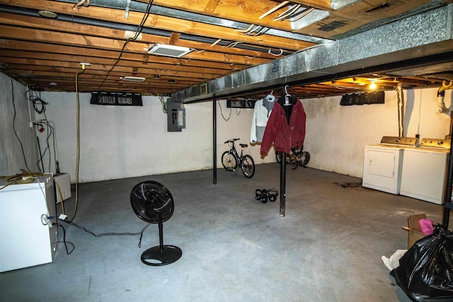 unfinished below grade area with washer and dryer and electric panel
