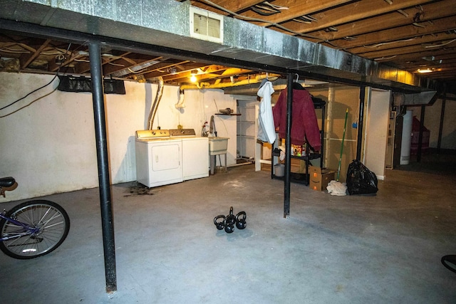 unfinished basement with visible vents and independent washer and dryer