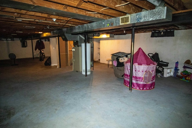 unfinished basement featuring water heater