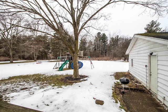 snowy yard with a playground