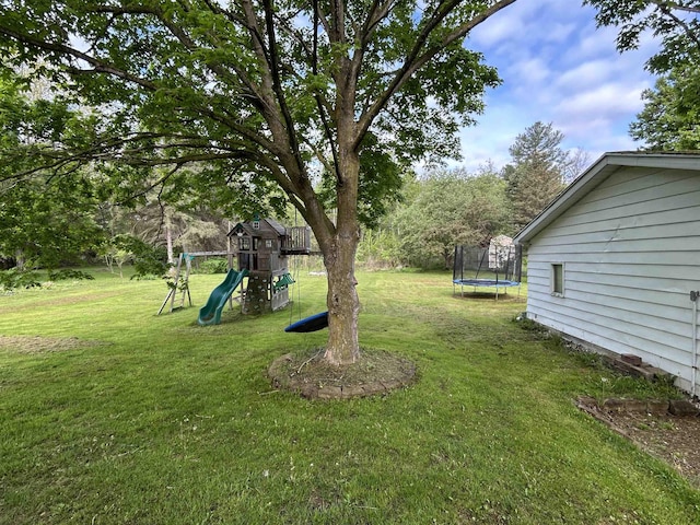 6455 Turner Rd, Flushing, MI 48433 - view of grassy yard featuring a trampoline and a playground