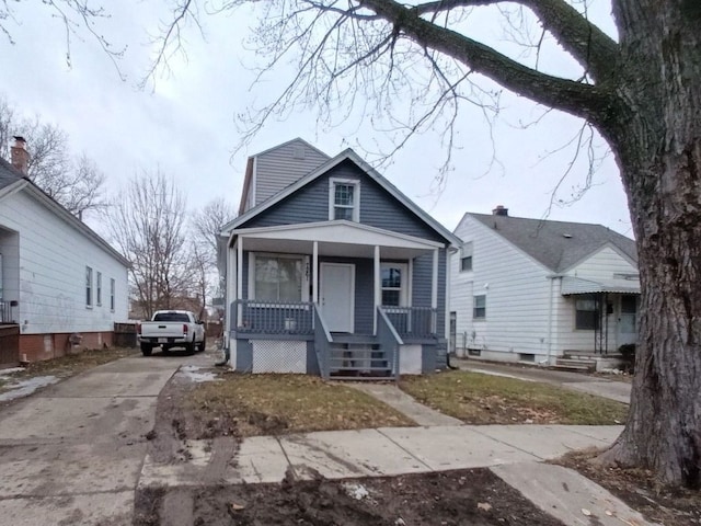 view of front of home with a porch and driveway