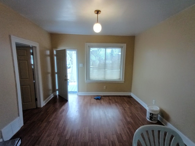 entrance foyer with baseboards and wood finished floors