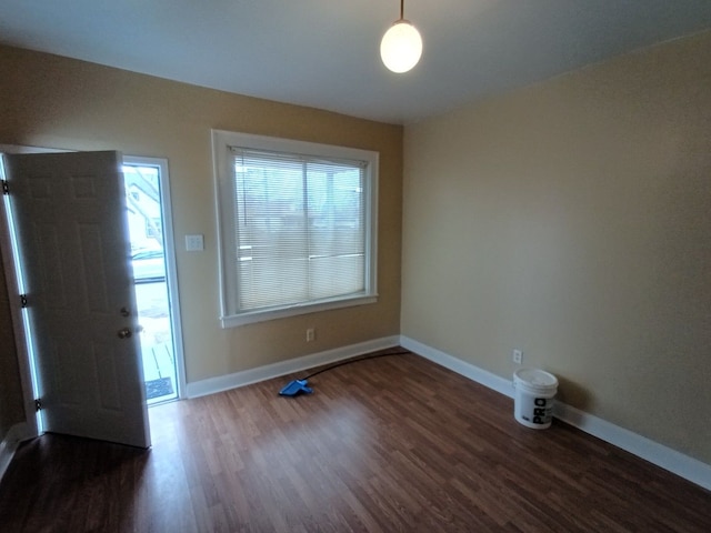 entryway featuring baseboards and wood finished floors