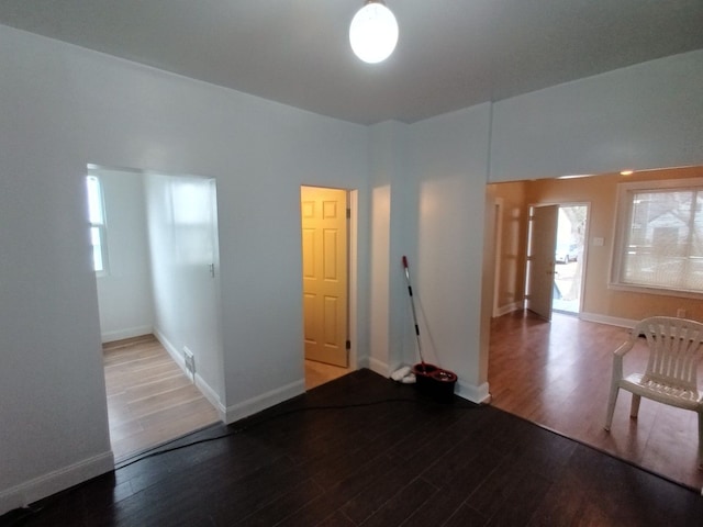 unfurnished room featuring baseboards and wood finished floors