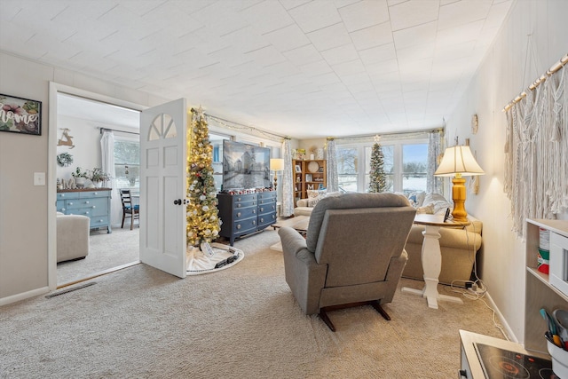 living room featuring baseboards, visible vents, a wealth of natural light, and light colored carpet