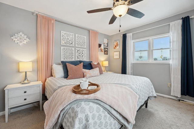 carpeted bedroom with ceiling fan and baseboards