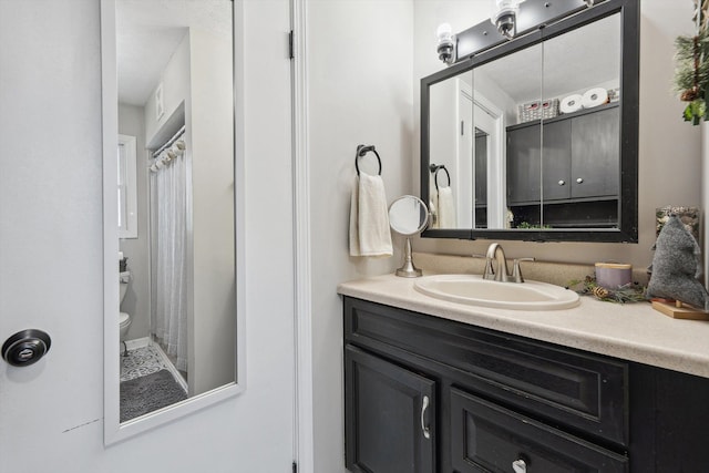 full bathroom featuring a shower with curtain, vanity, and toilet