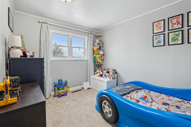 carpeted bedroom with baseboards and ornamental molding