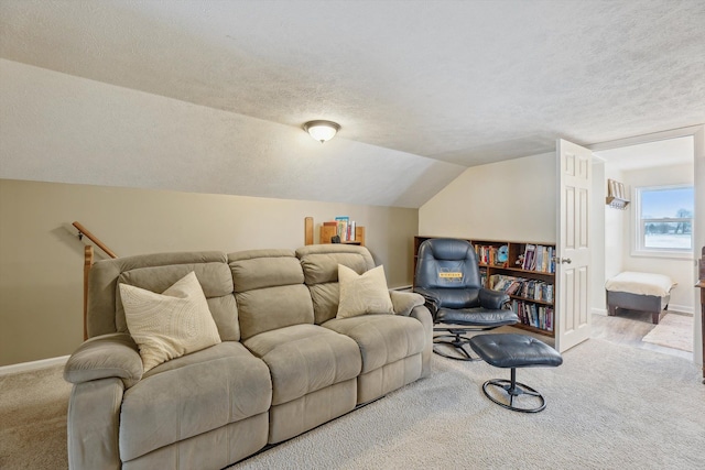 carpeted living room featuring a textured ceiling, vaulted ceiling, and baseboards