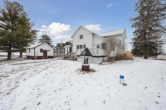 snow covered property with a wooden deck