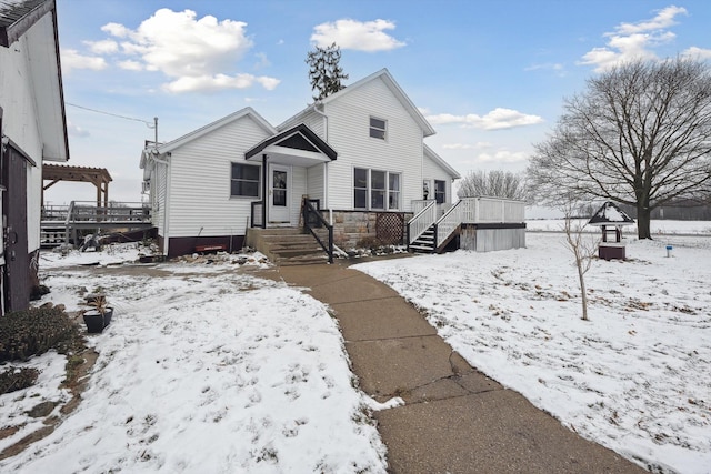 view of front of property featuring stone siding and a deck