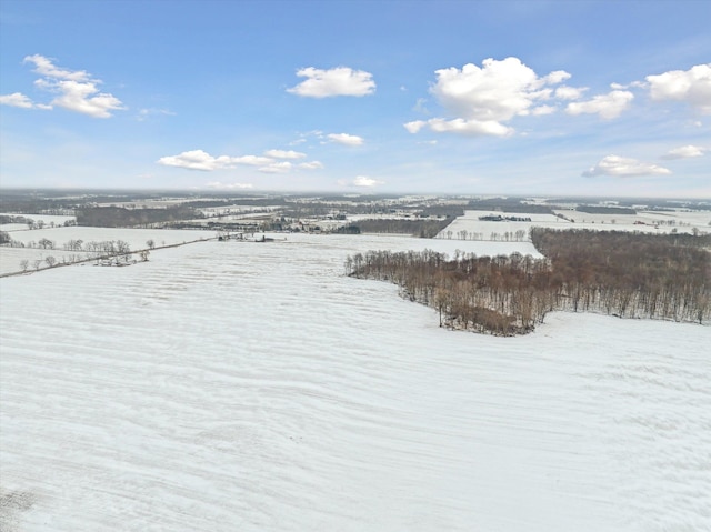 snowy aerial view with a water view