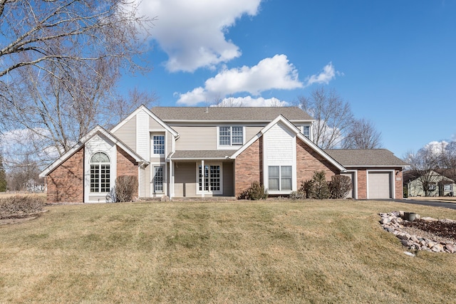 traditional-style house featuring an attached garage, a front lawn, and brick siding