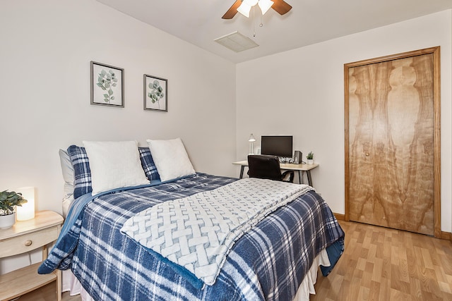 bedroom with ceiling fan, baseboards, and light wood-style floors