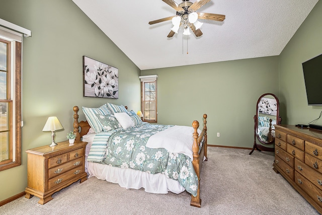 bedroom with light carpet, vaulted ceiling, baseboards, and ceiling fan