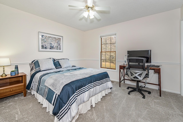 bedroom featuring a textured ceiling, carpet floors, a ceiling fan, and baseboards