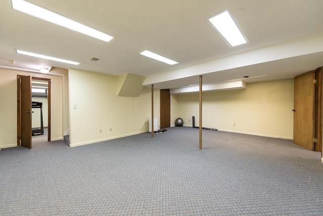 finished below grade area with carpet flooring, visible vents, and baseboards