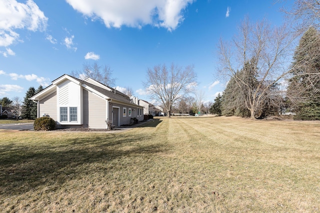 view of side of home with a yard