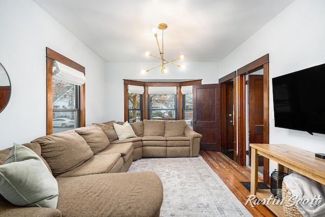 living room with a chandelier and wood finished floors