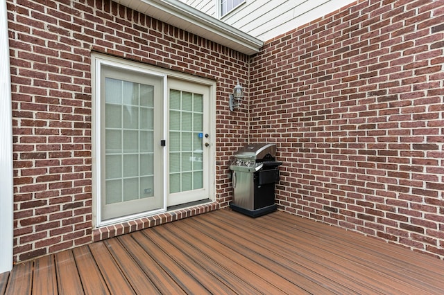 wooden deck featuring a grill