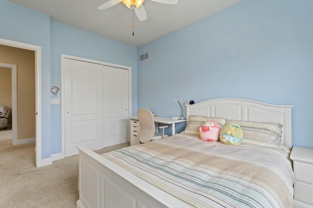 bedroom featuring a closet, light colored carpet, visible vents, ceiling fan, and baseboards