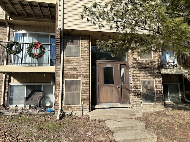 property entrance with brick siding