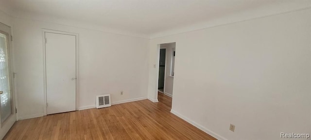 unfurnished bedroom with visible vents, baseboards, and wood finished floors