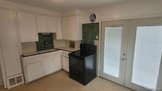 kitchen featuring french doors, visible vents, black range with electric stovetop, and white cabinets