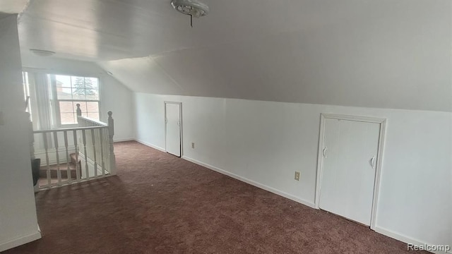 bonus room featuring carpet floors, baseboards, and lofted ceiling