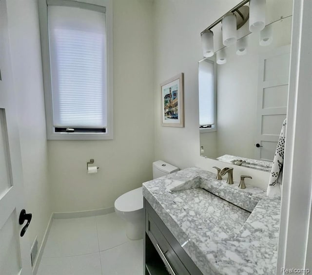 bathroom with toilet, tile patterned flooring, baseboards, and vanity