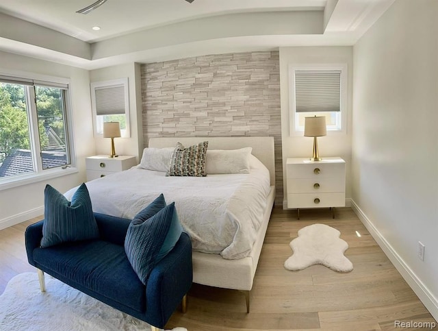 bedroom with baseboards, wood finished floors, and recessed lighting